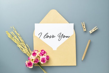 Mockup postcard and envelope on white background with craft rose flower. Mock up for elegant design....