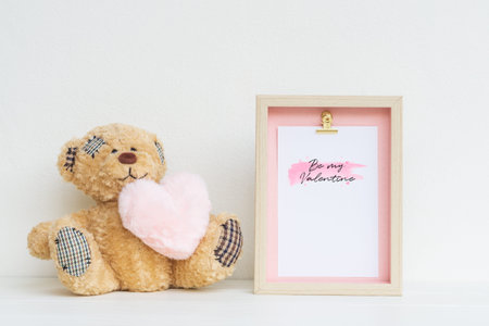 Mockup Picture frame and cute bear with pink heart. Valentines Day Background concept with copy space. Mock up with photo frame and teddy bear with space for your picture or textの写真素材