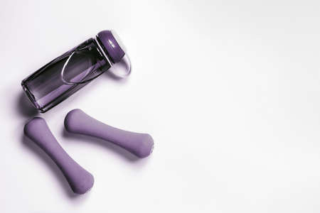 Still life top view of  dumbbells and bottle of water isolated on White. Fitness, sport and healthy lifestyle background Concept.の写真素材