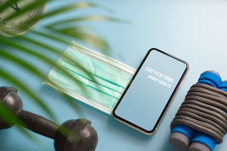 Stay Fit At Home, Healthy at home for quarantine times in Coronavirus pandemic outbreak background concept. Mockup mobile phone for Be Active during virus pandemic. Fight Covid-19の写真素材