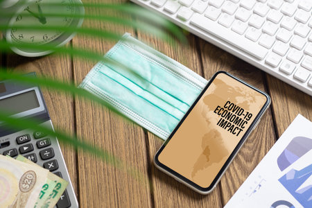 Coronavirus Covid-19 pandemic outbreak economic impact background concept. Mockup mobile phone with...
