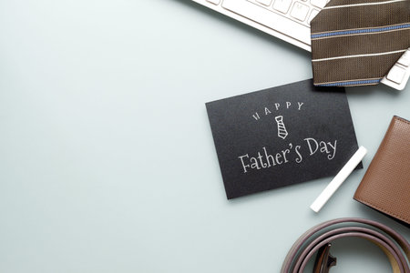 Happy father's day message on chalkboard. Flat lay composition on  working desk with laptop...