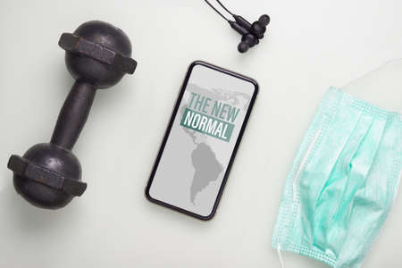 Flat lay Smartphone, dumbbell, earphone and face mask  for Workout at Homeの写真素材