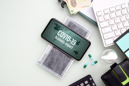 Coronavirus Covid-19 Business impact background concept. Mockup mobile phone on facemask with...