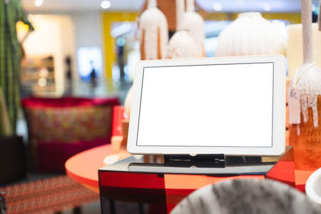 Mockup blank white screen tablet on table for your adverstisement text or artwork.の写真素材