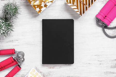 Mockup blank cover black book for New Year resolutions healthy background concept on grunge whtie Christmas ornaments and fitness equipments. Mock up blank cover black book.の写真素材