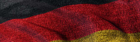 Close of grunge German flag. Grunge flag of Germany abstract 3D illustration. Dark and grungy national flag of the Federal Republic of Germany on denim fabric texture for web banner 3D rendering.の写真素材