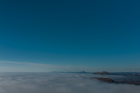 Rare early morning winter fog over the city skyline of the sea bay and skyscrapers before sunrise.の写真素材