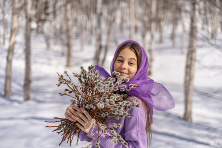The girl walks among the birches, collects willow, rejoices, laughs, holds in her hands, Easter...