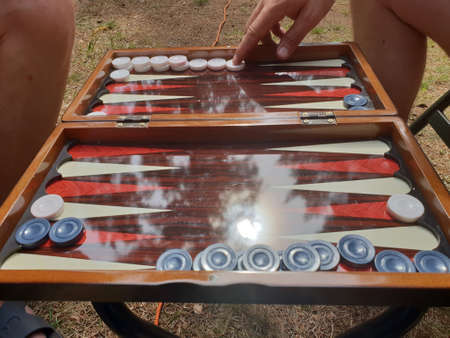 Two players playing backgammon board game