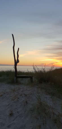 The bench made from tree in the Baltic sea beachの写真素材
