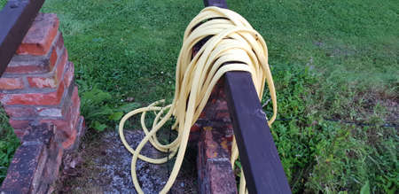 Hose for water placed on bridgeの写真素材