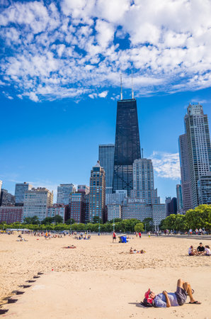 CHICAGO-August 18  John Hancock building on Michigan Av in Chicago,IL with people on the beach August 18,2013  In 1968, it was the tallest building outside of New York  It stands next to Water Tower Place のeditorial素材