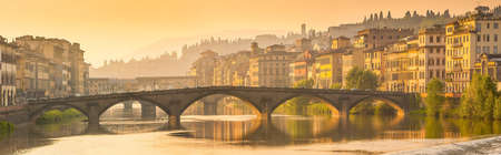 Florence, Ponte alla Carraia medieval Bridge landmark on Arno river, sunset panorama の写真素材
