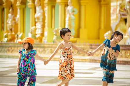 YANGON - MYANMAR - November 15, 2013: Unidentified Burmese children walking together with thanaka on their face on November 15, 2013 in Yangon, Myanmar. Thanaka is a yellowish-white cosmetic paste made from ground bark.のeditorial素材