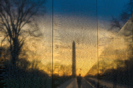 Vietnam War Memorial with a reflection of  Washington Monument at sunriseのeditorial素材