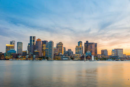 Boston downtown skyline panorama with skyscrapers over water at twilightの写真素材