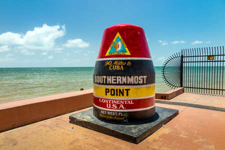 The Key West, Florida Buoy sign marking the southernmost point on the continental USA and distance to Cuba.の写真素材