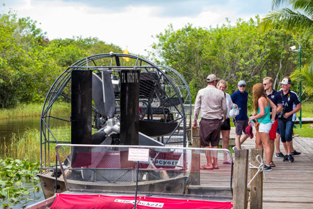 EVERGLADES, UNITED STATES - August 10, 2014: group of tourists riding an airboat. The Everglades are a natural region of wetlands in the southern portion of the U.S. state of Florida.のeditorial素材