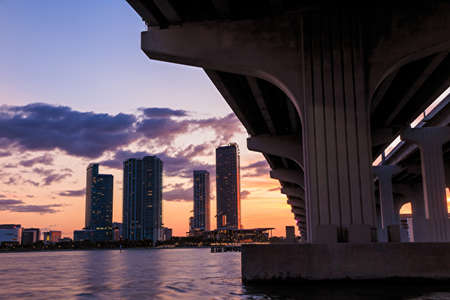 Miami city skyline panorama at twilight with urban skyscrapers, marina and bridgeの写真素材