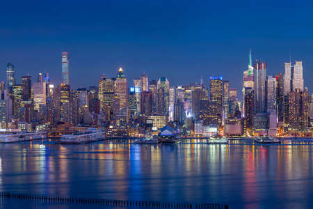 New York City with skyscrapers illuminated over Hudson River panoramaの写真素材