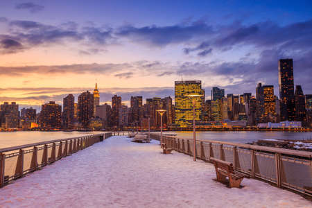 New York City with skyscrapers illuminated over Hudson River panoramaの写真素材