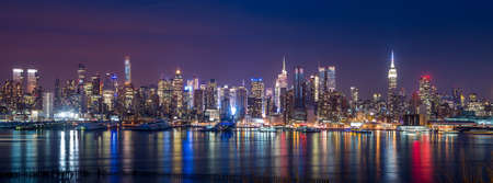 New York City with skyscrapers illuminated over Hudson River panoramaの写真素材