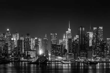 New York City with skyscrapers illuminated over Hudson River panorama in black and whiteの写真素材