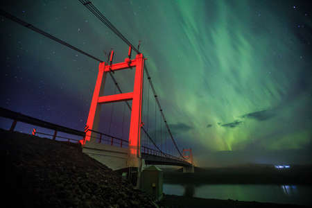 Auroral display over the glacier lagoon Jokulsarlon in Iceland.の写真素材