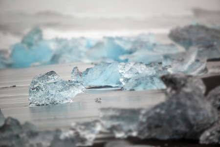 Beautiful beach in the South of Iceland with a black lava sand with icebergs from glaciersの写真素材