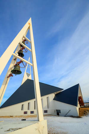 Olafsvik Church (Olafsvikurkirkja) at foot of massive, steep Enni mountain in Icelandの写真素材
