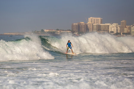 RIO DE JANEIRO, BRAZIL - JULY 17: Brazilians with surfboard into the water at Copacabana Beach on July 17, 2015.のeditorial素材