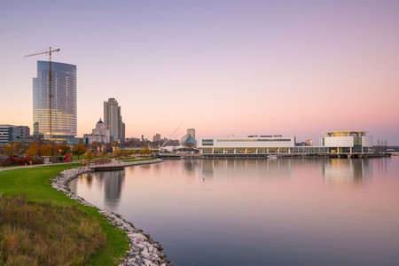 Milwaukee skyline at twilight with city reflection in lake Michigan and harbor pier.のeditorial素材