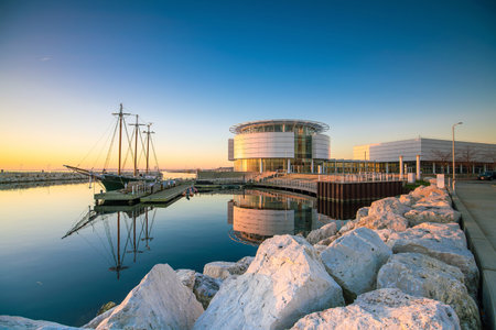 Milwaukee skyline at twilight with city reflection in lake Michigan and harbor pier.のeditorial素材