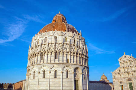 Pisa Baptistry of St. John in a sunny day in Italy.の写真素材