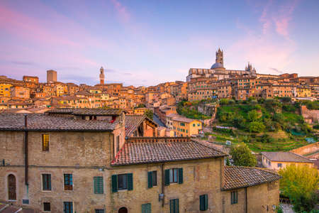 Downtown Siena skyline in Italy at twilightの写真素材
