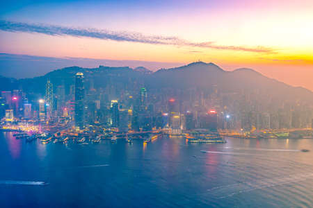 Hong Kong city skyline with Victoria Harbor view at twilight from top viewの写真素材