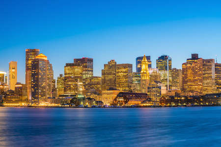 Panorama view of Boston skyline with skyscrapers over water at twilight in United States