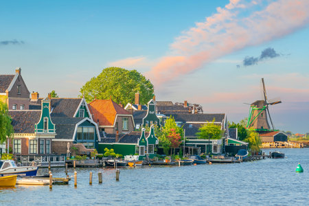 Traditional old village with dutch windmills in Amsterdam, Netherlands at sunsetの写真素材