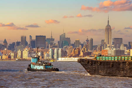 Cargo ship with Manhattan city skyline  of New York from New Jersey in USAの写真素材