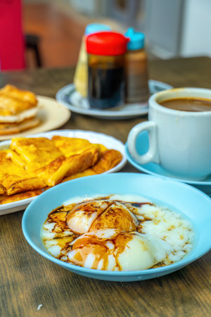 Traditional breakfast set and coffee, boiled eggs and toast, popular in Singapore and Malaysiaの写真素材