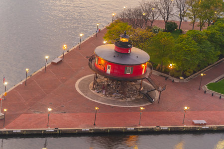 Red lighthouse at night, the Inner Harbor in Baltimore, Maryland USAの写真素材
