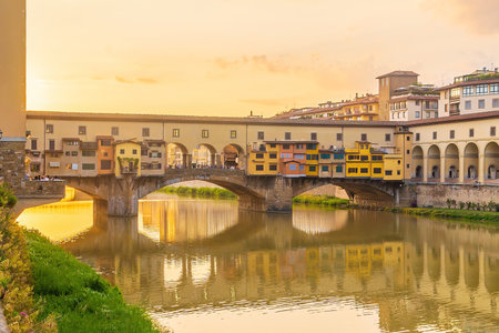 Ponte Vecchio over Arno river in Florence, Italy at beautiful sunsetの写真素材