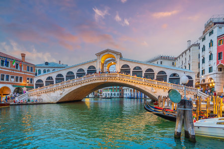 Panoramic view of famous Canal Grande with famous Rialto Bridge at sunset in Veniceの写真素材