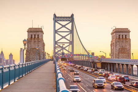 Downtown Philadelphia city skyline, cityscape of  Pennsylvania in USA with Ben Franklin Bridge at sunsetの写真素材