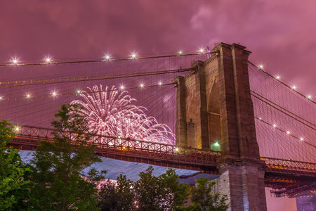 July 4th fireworks at Brooklyn bridge Manhattan skyline New York USA at nightの写真素材