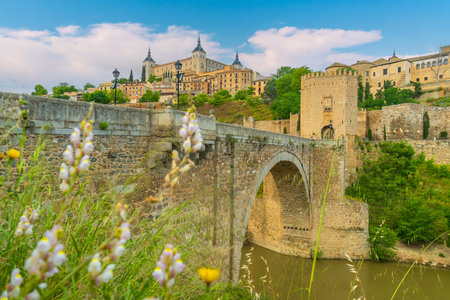 Alcazar and Alcantara Bridge, an arch bridge in Toledo, Spainの写真素材