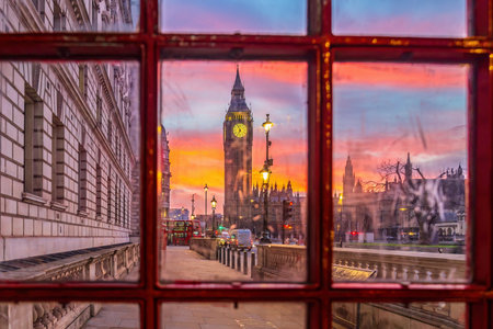 Big Ben tower of Houses of Parliament with telephone booth, Westminster in London, UK at sunriseの写真素材