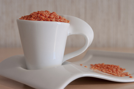 Red lentils in porcelain coffee setの写真素材