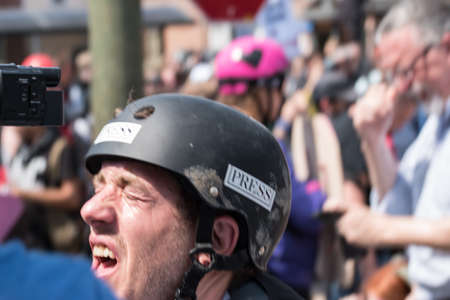 Charlottesville, Virginia USA August 12, 2017 Press photographer injured by bottle of homemade liquid cayenne pepper tossed by protester in crowdのeditorial素材